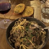 Pappardelle (spaghetti) funghi e tartufo, garlic bread (both asked to be made vegan) and Pinot noir.   at Maccaroni Trattoria Italiana in Melbourne