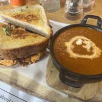 Truffle cheddar cheese with caramelized onions on sourdough served with tomato & basil soup with coconut cream and crispy onions  at Kaylee's in Johannesburg