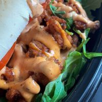 Close up of the Rich Boi - breaded oyster mushrooms and remoulade, with arugula and tomato at Willowbeez Soulveg in Columbus
