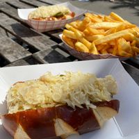 Bratwurst sausage on a pretzel bun with sauerkraut  at Vegan Brüder in Fort Lauderdale