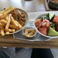 Vegan chicken bowl with a side of chips and vegan Greek salad and smokey eggplant dip.   at Zeus Street Greek in Canberra