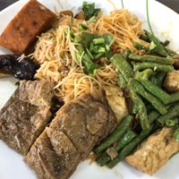 Fried mee Siam with side dishes include otah  at Taste of Vegetarian in East Singapore