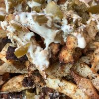 Messy Za'atar Fries
Baked fries seasoned with za'atar and cayenne, and topped with garlic cashew sauce and pickled jalapeños at Nourishmoi in Mississauga