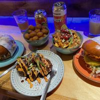BBQ beef burger, kimchi chicken burger, Thai fries, tots, and cauliflower   at Wholesome Junkies in Manchester