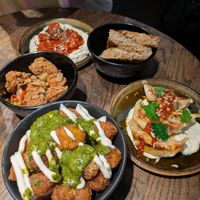 Pesto tots, dumplings, salt and pepper chicken, whipped tomato tofu with sourdough at Wholesome Junkies in Manchester