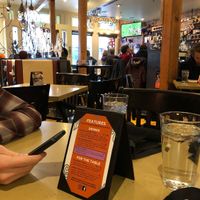 Inside of the restaurant. Lots of seating and full bar with two flats screens playing sports games.  at Marco's Coal-Fired - Ballpark in Denver