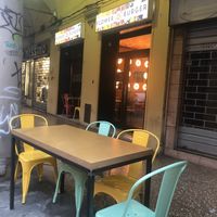 outside seating area and entrance  at Flower Burger in Bologna