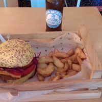 Yummy burger with fries and beer. at Flower Burger in Bologna