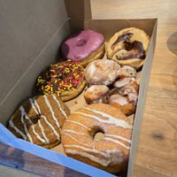 To left to right: blueberry, cookie butter, chocolate sprinkle, apple fritter, coffee, cinnamon bourbon at Pepperbox Doughnuts - Design Center  in Charlotte