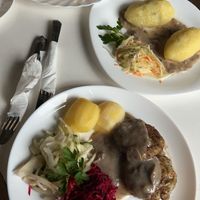Mushroom cutlets and two different kinds of potato dishes with mushroom sauce and a variety of salads at Vilties Vaistinės Arbatine in Kaunas
