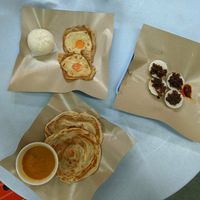 BBQ 'pork' bun, vegan eggs, roti Chennai and some white glutinous thing topped with fried onions that was delicious! at E-PACS Vegan Cafe in East Tamaki