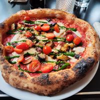 "Mozzarella", eggplant and date tomatoes pizza at Piu - Schiffbau in Zurich