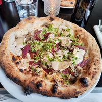 Onion and "mozzarella" pizza at Piu - Schiffbau in Zurich