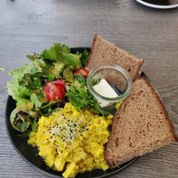 Scrambled eggs I think made from tofu, a nice fresh salad with a vegan honey mustard dressing and sourdough bread I believe at Liebling Trier in Trier