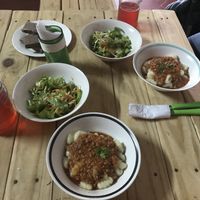 Cassava gnocchi with bolognese sauce textured and sliced ​​vegetable ham, raw salad of white lettuce, tomato, carrot, cucumber and beetroot, water of Jamaica flower. at Señor Conejo in Asuncion