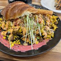 ARGI Signature beans with scrambled tofu, cheese, hash brown, bacon, and tomato on croissant.  at Argi in Kensington