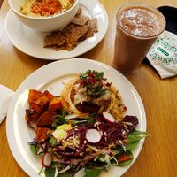 Tahini burger on brown rice, hummus in background and vanilla-cacao smoothie to the right! at Kupfert & Kim - Yorkville in Toronto