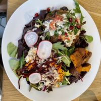 Tahini burger on green  at Kupfert & Kim - Yorkville in Toronto