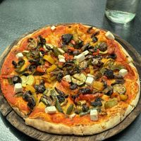 Tasty vegan Pizza on the menu. They also sell smoothies, Pasta and vegan banana bread.  at The Old House  in Karnataka