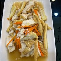 a corn, carrot and tofu dish with savory juicey sauce at Vegan Center Cafe in Vientiane