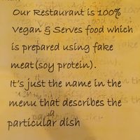 Vegan sign on every table  at Vegan Center Cafe in Vientiane