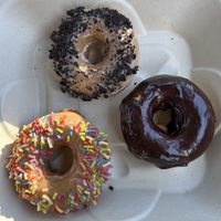Vanilla with Oreo, plain chocolate, maple with sprinkles  at Maui Ono Donuts in Kihei
