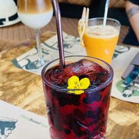 Iced latte with oat milk, orange ginger juice, and hibiscus wild berry iced tea  at Pandora Greenbox in Split