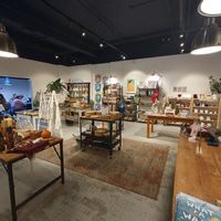 Eco shop and further seating through archway at Open House Deli in Winchester