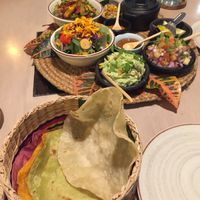 Vegan burritos with beans, sauteed veggies, salad, corn, pico de gallo, guacamole, and homemade tortillas at MUYU in Puerto Baquerizo Moreno