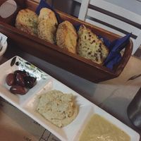 Complimentary bread, olives, hummus and garlic dip at Oniro Art Meze in Rhodes