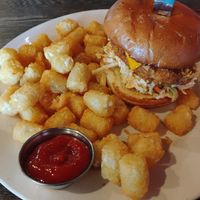 The Kosher Kowboy chick'n sandwich with tater tots at Plant Based Mafia in Palm Beach Gardens