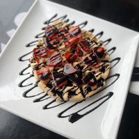 Waffle with chocolate sauce and strawberries  at Creams Cafe in Newcastle Upon Tyne