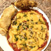 Vegan pizza, curry “chicken” drumstick, empanada  at DeeGee's Vegan 360° in Richmond Hill