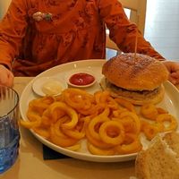 My daughters burger with fries, she ordered without fresh greens in it. at Cavo Bistrot in Cagliari