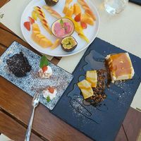 Mix di dolci: brownie con panna, cheesecake e macedonia con gelato at Cavo Bistrot in Cagliari