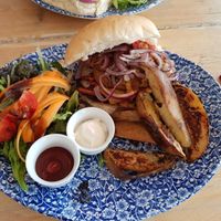 Seitan burger with vegan mayo. Usually comes with hash browns or sweet potato fries but they had sold out so they made us some potato wedges.  at Chapter 2 Coffee Shop  in Llandudno