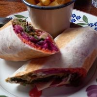 Seitan and vegetable/ salad wrap with garlic and parsley fries. at Cosmic Kitchen in Plymouth