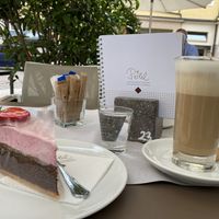 Vegan cake and latte with oat mill at Cafè Konditorei Confiserie Pöhl in Merano