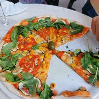 Pizza with vegan cheese, tomato, zucchini, Rucola salad and corn at Rica in Rijeka