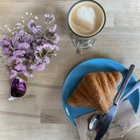 Oat latte and croissant at Parlé Pantry in West London
