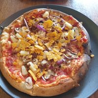 Vegan pizza with tomato sauce, red onions, mushrooms, pineapple and vegan cheese and soy meat at Askur Taproom in Egilsstadir