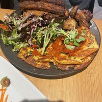Irene’s Big Breakfast. Chick pea omelette with ranchero sauce, tempeh bacon, salad, sliced potates, and two pieces of buttered sourdough bread / Le Grand Petit déjeuner  at Hello 123 in Montreal