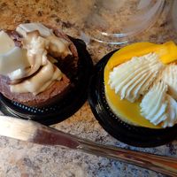 Vegan cheesecakes from VegFest: chocolate and mango yuzu. Took a small slice from each. Heavenly!!! at Foodhisattva in Cleveland Heights