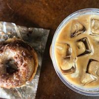 Vegan Sunshine Donuts apple fritter donut and caramel knowledge iced latte with almond milk  at Black Crow Coffee Co - 1st Ave in St Petersburg