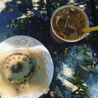 Vegan Sunshine Donuts chocolate peanut butter donut and caramel knowledge iced latte with almond milk  at Black Crow Coffee Co - 1st Ave in St Petersburg