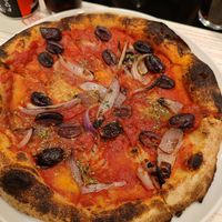 Pizza with olives and red onions at Berberè in Verona
