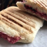 Beetroot hummus & black olive panini  at Meli Cafe in Newcastle Upon Tyne
