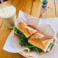 Benefit Baguette made with arugula, roasted peppers, and olive tapenade. And then I added pickled onion and pickled carrot for extra toppings. Smoothie is the Nutty Monkey.  at Benefit Juice Bar & Cafe in Providence