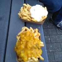 Big fries from Jorgen's one with pickle sauce (vegan) one with veganaise. On the nice bench across from the frituut.  at Jorgen's Friethuisje in Tienen