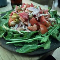 I really liked this salad a lot. Arugula , tomatoes, onion, olives.  This is the cheaper of two salads and has nothing nonvegan by default. 100 pesos  at Boulenc in Oaxaca